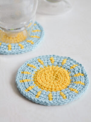 Little sun Tunisian crochet coaster pattern in use