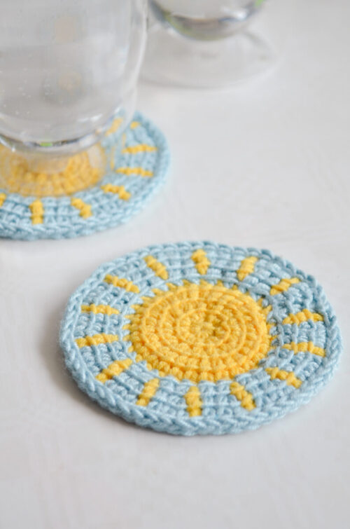 Little sun Tunisian crochet coaster pattern in use