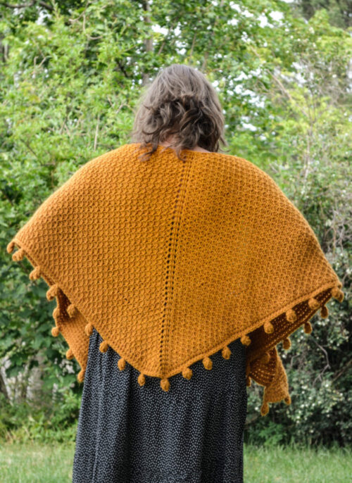 One way of wearing a Tunisian crochet shawl - around the shoulders seen from the back